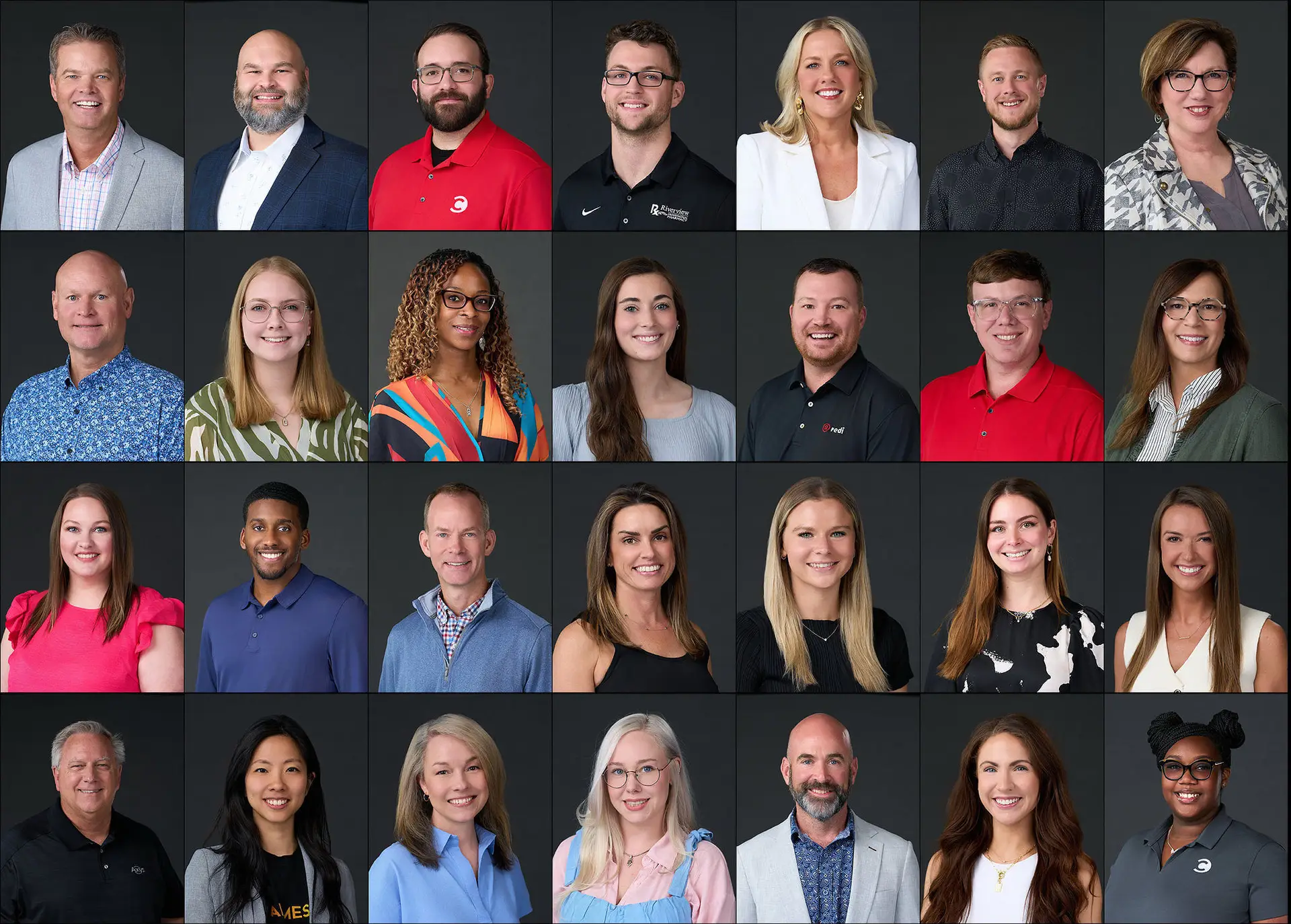 Grid of professional corporate headshots showing a diverse group of business professionals against a dark gray backdrop